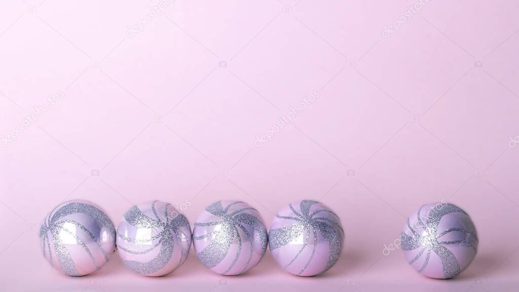 Christmas composition. Set of christmas pink decorations, shiny balls on pastel background. Mock up for new year gretting card. Copy space for text or lettering