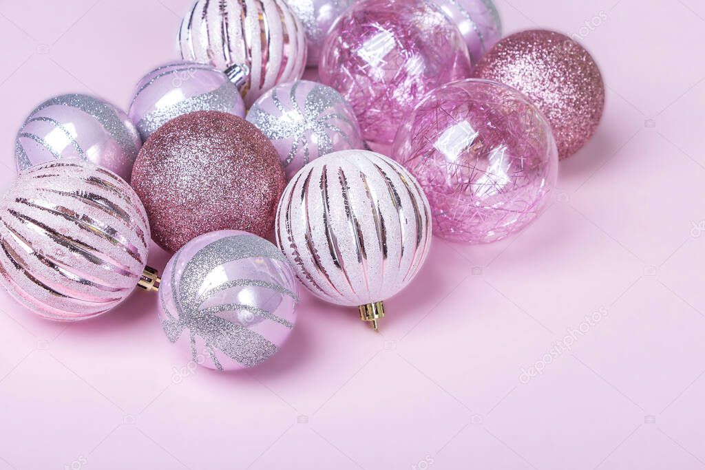 Christmas composition. Set of christmas pink decorations, shiny balls on pastel background. Mock up for new year gretting card. Copy space for text or lettering, close up