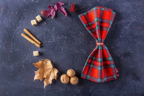 Autumn harvest festival and thanksgiving day table setting. Frame from fallen leaves, nuts and checkered napkin. Thanksgiving rustic still life, mock up