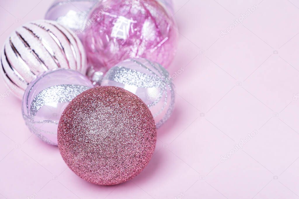 Christmas composition. Set of christmas pink decorations, shiny balls on pastel background. Mock up for new year gretting card. Close up, copy space
