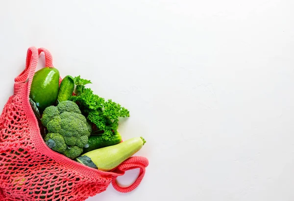 String bag with green vegetables. Zero waste concept, flat lay, copy space.