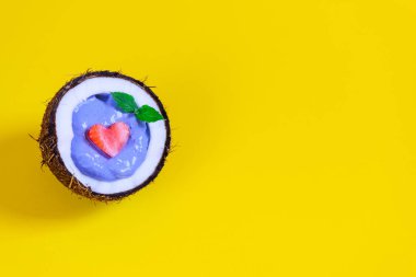 Sarı bir arka plan üzerinde bir hindistan cevizi çilek ve meyve ile Mavi matcha smoothie. Kopyalama alanı, horisontal oryantasyon.