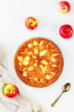 Charlotte beyaz bir masada elmalı turta. Düz döşeme, dikey yönlendirme, yakın çekim.