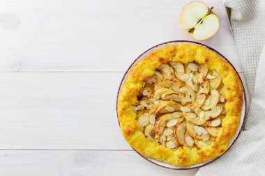 Ahşap bir masada tarçın ve badem ile Elma galette. Ev yapımı turta. Düz döşeme, kopyalama alanı.