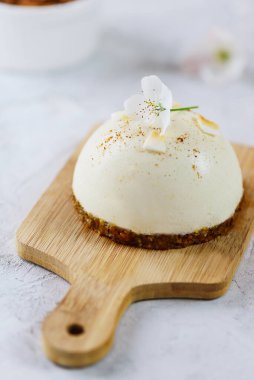 Ahşap bir tahtanın üzerinde kremalı pasta. Şeker, glüten, laktoz yok..