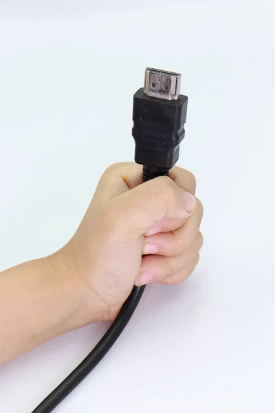 HDMI-kabel in Kid hand op witte achtergrond. — Stockfoto