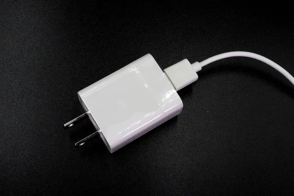 USB mobile charger isolated on black background