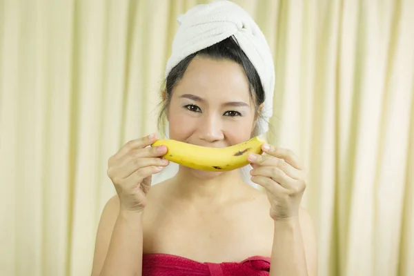 woman holding banana acting smile, sad, funny, wear a skirt to c