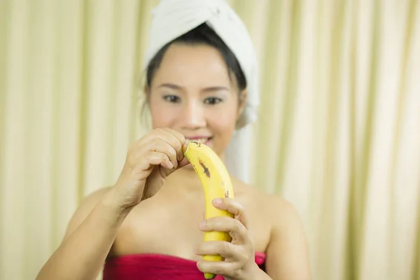 woman holding banana acting smile, sad, funny, wear a skirt to c