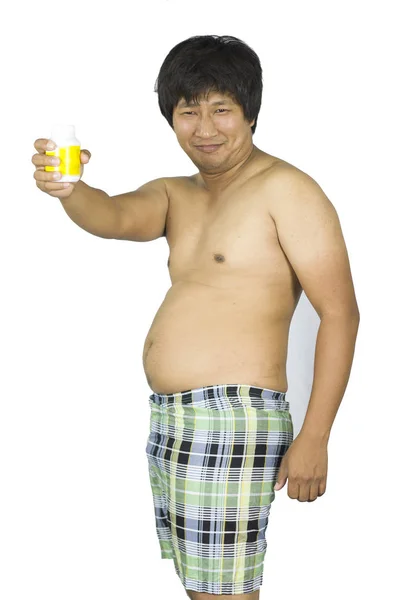 Fat guy holding a yellow jar of pills on white isolated backgrou — Stock Photo, Image