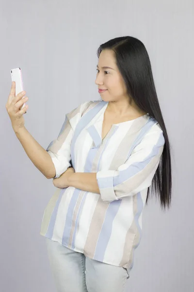 cute beautiful woman in shirt acting playing on phone.  Isolated