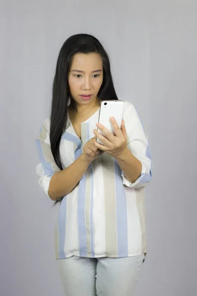 Cute beautiful woman in shirt acting playing on phone.  Isolated — Stock Photo, Image
