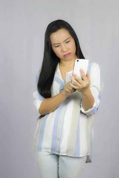 Cute beautiful woman in shirt acting playing on phone.  Isolated — Stock Photo, Image