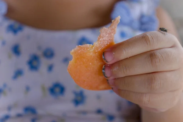 Children eating food with dirty hand and dirt lodged in the nail Stock Image