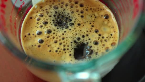 Großaufnahme von Espresso, der aus der Kaffeemaschine ausgeschenkt wird. Professionelle Kaffeezubereitung — Stockvideo