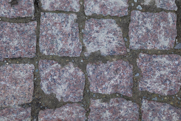 Top view on old granite cobblestones close up