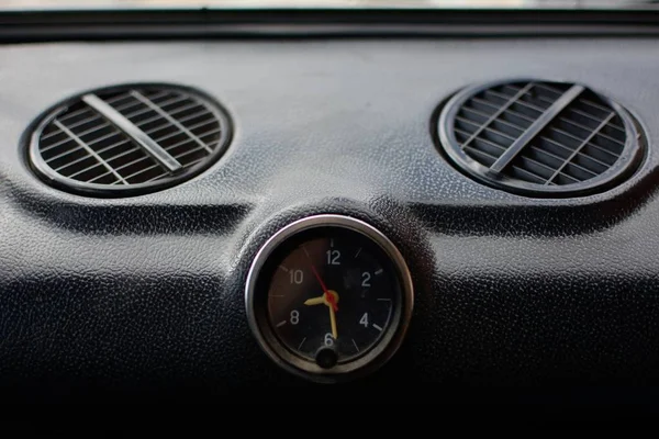 Black control panel with heater grilles and a clock with hands in an old Russian car — Stock Image Black Control Panel Heater Grilles Clock Hands Old Russian Car Stock Picture