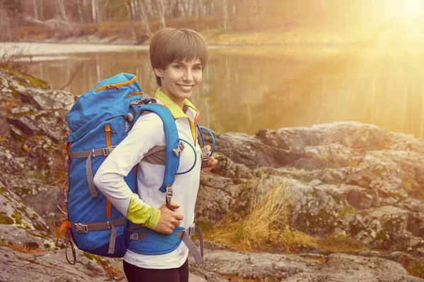 Walking woman with a backpack. Outdoor sports portrait