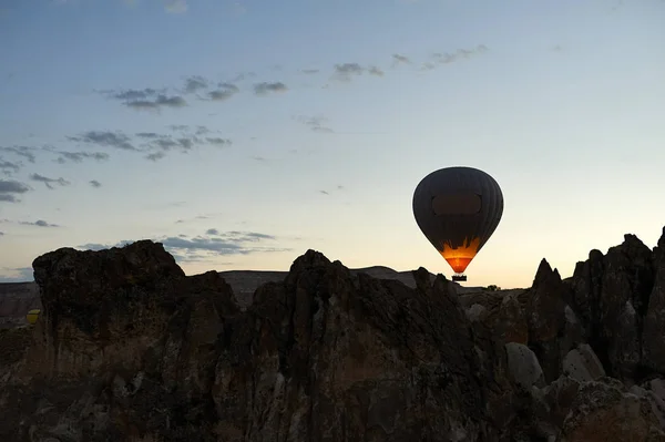 Hot Air Balloon Flight Cappadocia Tour Goreme Open Air Museum, Flying hot air balloons rise in sunrise Cappadocia. Goreme National Park Turkey.