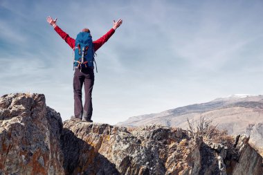 Sırt çantasıyla dağlarda gezen bir adam Seyahat yaşam tarzı başarı konsepti açık hava dağcılık sporu aktif tatil kavramı.