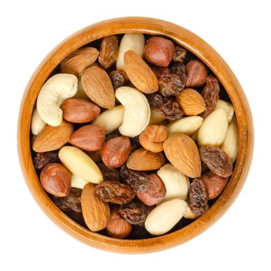 Nuts and raisins in wooden bowl. Snack mix of dried almonds, hazelnuts, cashews and raisins.Trail mix. Edible, raw, organic and vegan. Isolated macro food photo closeup from above on white background clipart