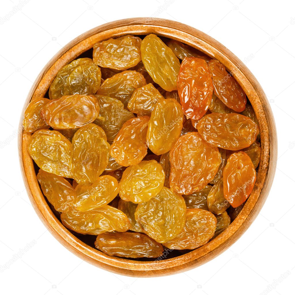 Sultanas, golden raisins, in wooden bowl