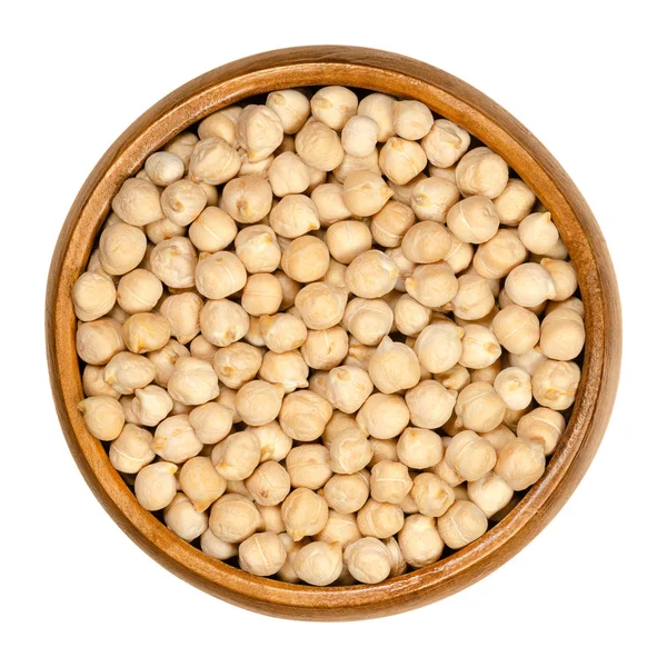 Dried chickpeas in wooden bowl over white — Stock Photo, Image