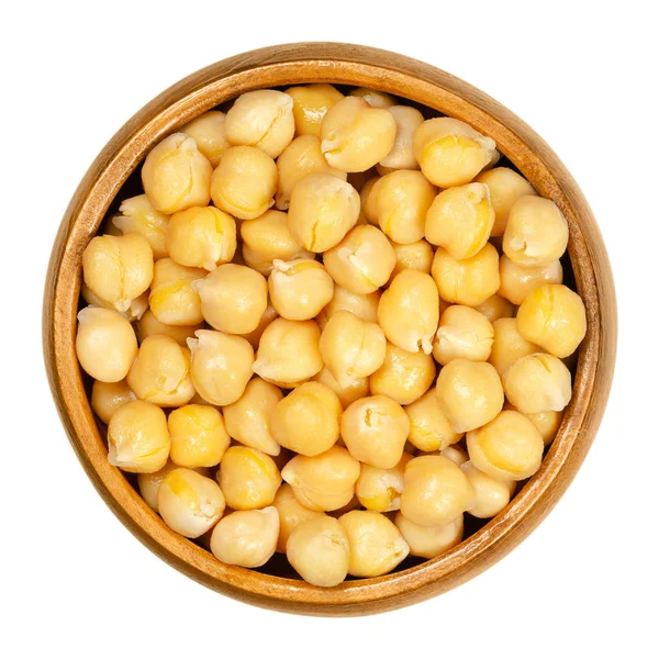 Cooked chickpeas in wooden bowl over white — Stock Photo, Image