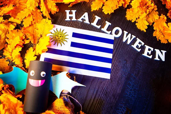 Holiday Halloween. Uruguay. Autumn holiday. Vampires against the background of yellow leaves. Decoration for the holiday Halloween in Uruguay. the flag of Uruguay.