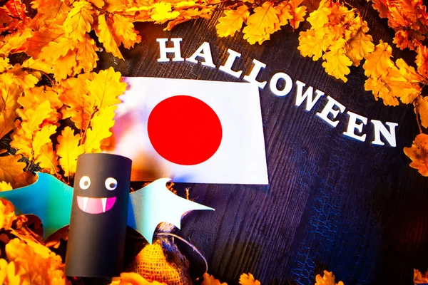 Holiday Halloween. Japan. Autumn holiday. Vampires against the background of yellow leaves. Decoration for the holiday of Halloween in Japan. the flag of Japan.