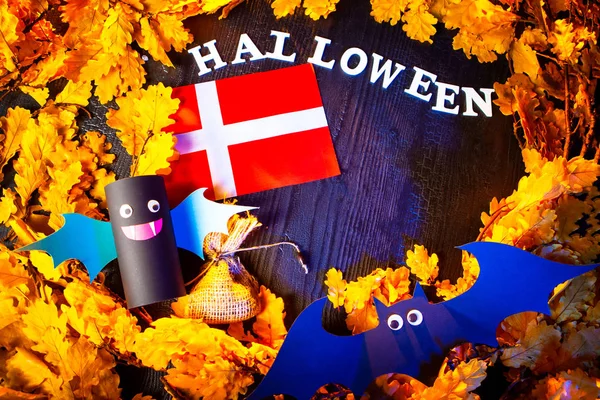 Holiday Halloween. Denmark. Autumn holiday. Vampires against the background of yellow leaves. Decoration for the holiday of Halloween in Denmark. flag of Denmark.