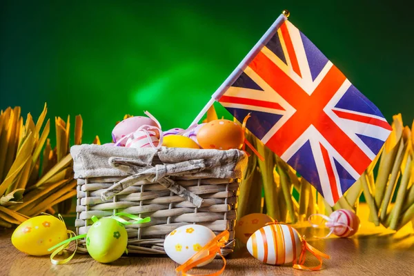 Holiday of Easter in England. Holidays in England. Colored eggs. Flag in the basket.