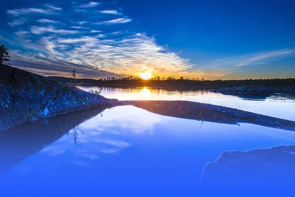 Sunset over the water. Wild nature of Finland. Summer evening. Lakes of Finland. Lakes and ponds in the wild.