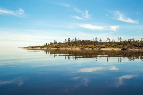 Russia. Karelia. Mirror reflection in water. Stones in the water. Ladoga lake. Karelia. Islands from a height. Ladoga lake.