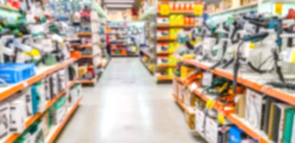 Blurred background. Shelves with goods. Goods for repair.  Sale of electric tools. Score. Hypermarket. Tool. Tool for repair on store shelves.