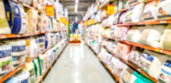 Blurred background. Shelves with goods. Household products. goods for bedroom. Sale of pillows. Score. Hypermarket. Linens. Odyala and pillows on the shelves of the store.