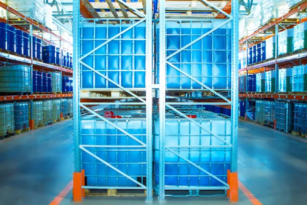 Plastic Barrels. Warehouse of chemical products. Stelazhy with barrels. Chemistry. Manufacture of chemicals. Pallets with barrels. Storage of chemicals.
