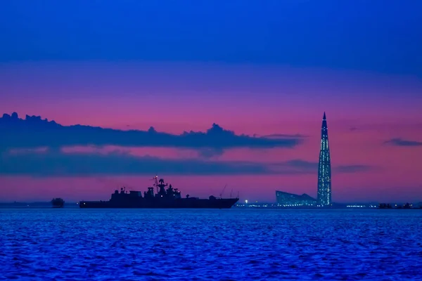 The warship sails at dusk. Rocket cruiser.