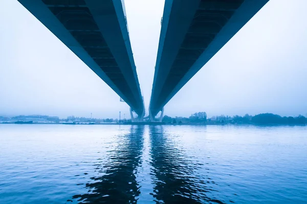 Bridge in the morning fog. Bridge over river. Fog over the river.