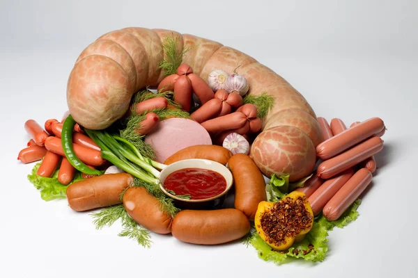 Sausages and sausages with greens. Meat delicacies.