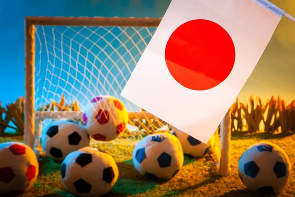 Football team of Japan. The flag of Japan with a soccer ball. Football championship. Japanese flag at the stadium. Team on football.