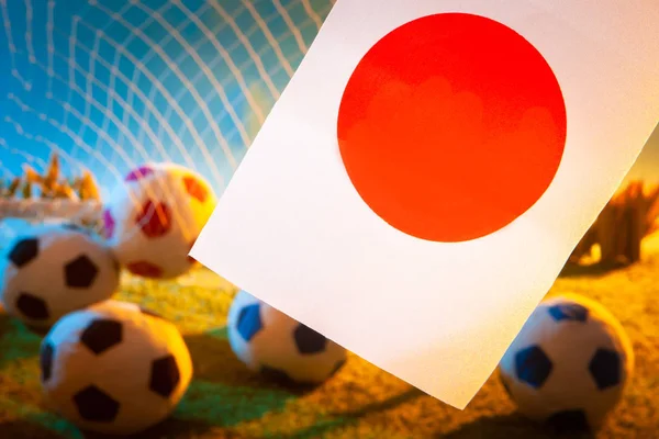 Football team of Japan. The flag of Japan with a soccer ball. Football championship. Japanese flag at the stadium. Team on football.