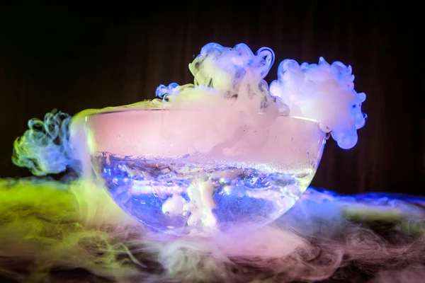 Dry ice in the jar. Steam from dry ice. Dry ice bubbles in the water. Evaporation of dry ice.