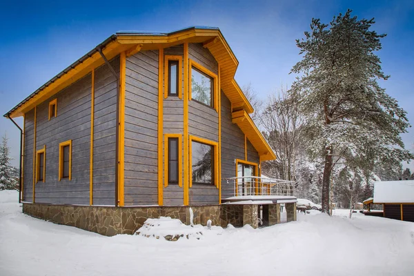 Country house. Two-storeyed mansion. Country house building. Camping.  Winter cottage. Wooden house on the stone foundation.