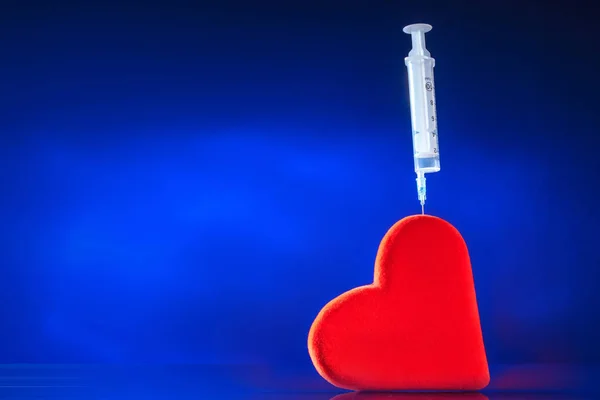 A syringe is inserted into the heart. Help with heart disease. Diseases. Treatment with injections. Heart failure.