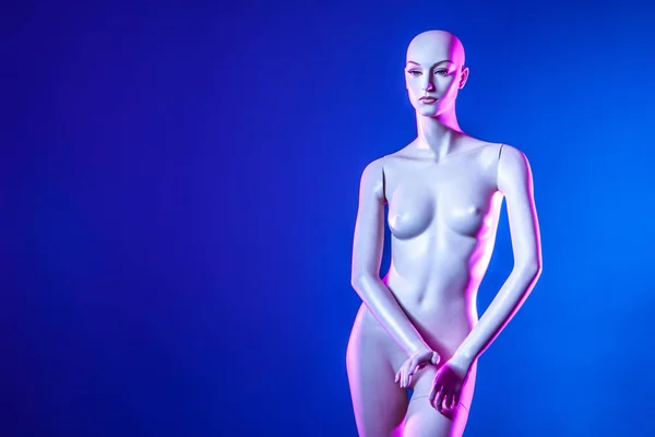 White mannequin woman on a blue background. mannequin fashion