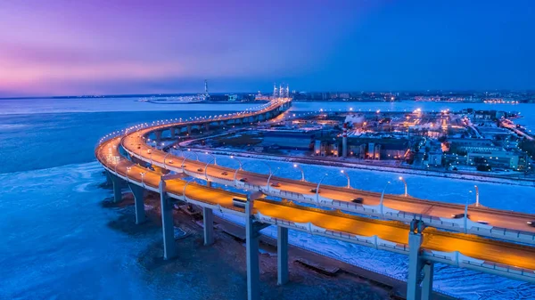 Industrial District. Highway. Industrial enterprise. Winter. Road from a height. Modern highway. Outskirts of St. Petersburg. Russia. The Gulf of Finland. Industrial district of St. Petersburg.