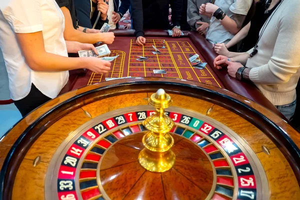 Casino. Roulette. People make bets. Gambling Roulette table with players. Cash games. People make bets on money. Underground casino. Gambling in the United States. Gambling business. Las Vegas.