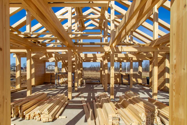 Construction of a cottage. The cottage is made of wood. House made of laminated veneer lumber. Construction technology. Surface of the house. Construction of a wooden house.
