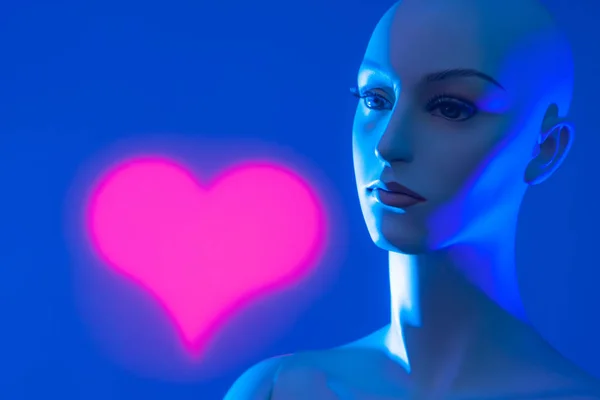 Dummy. Red heart. Neon light. Love. Artificial woman. Female robot